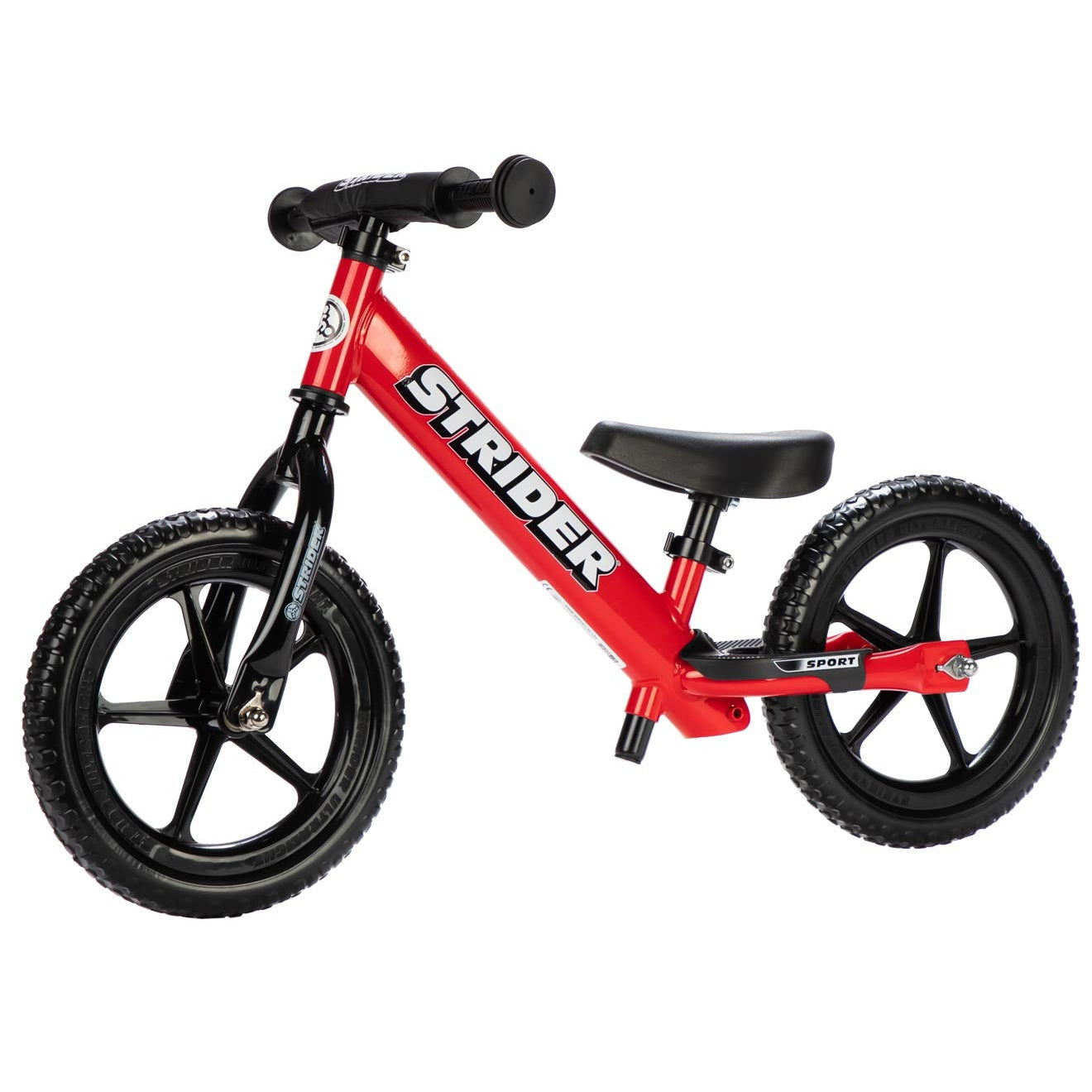 Red Strider balance bike on a white background