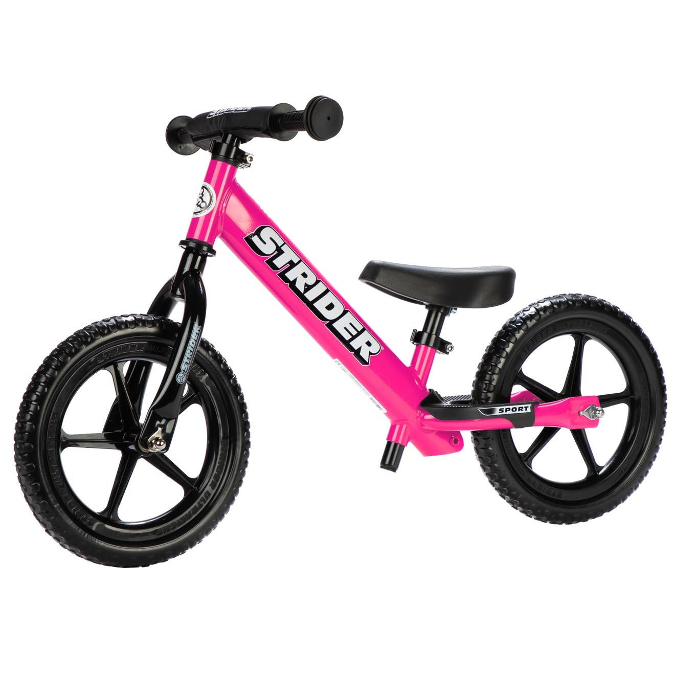 Pink Strider balance bike on a white background