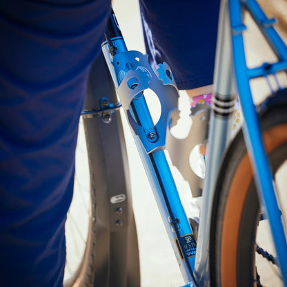Close-up of a blue bicycle frame with a blurred background