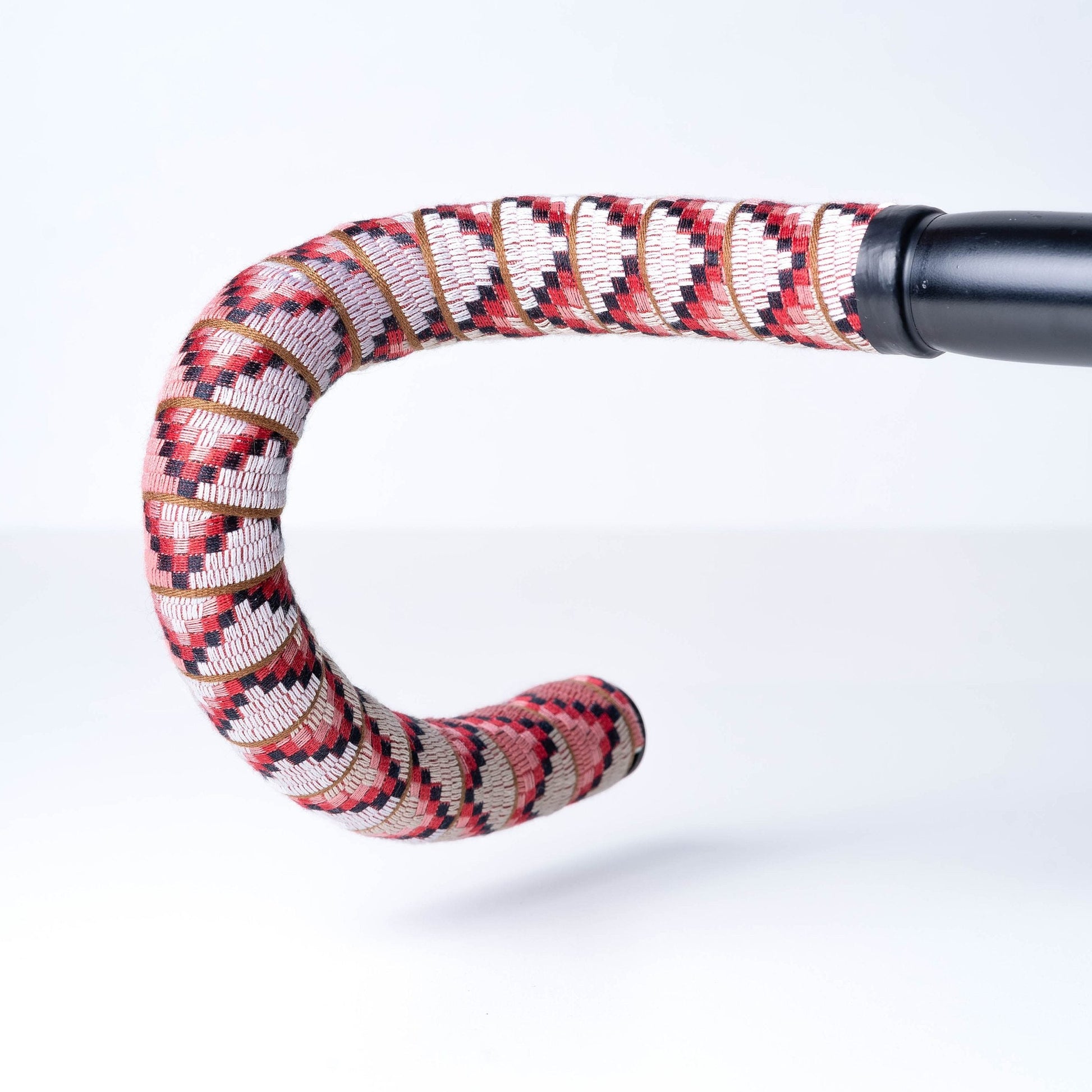 Decorative handle with red and white pattern on a white background
