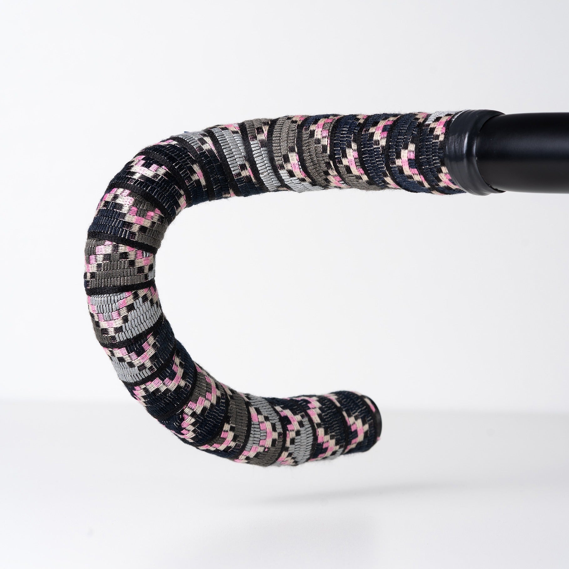 Decorative handle with a patterned wrap on a white background