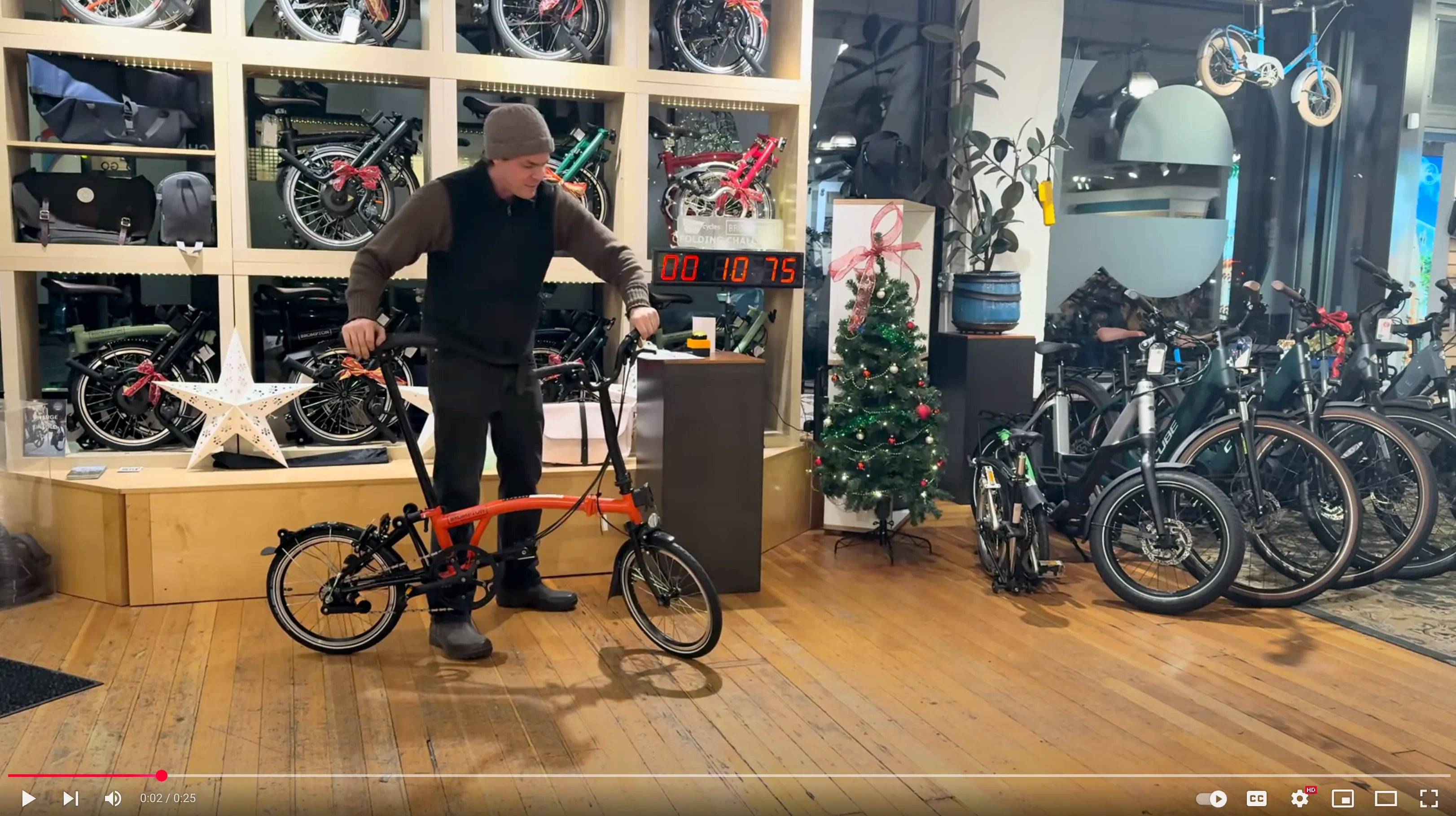 Load video: Video of the Brompton Folding Challenge — participants racing to fold a Brompton bike quickly.
