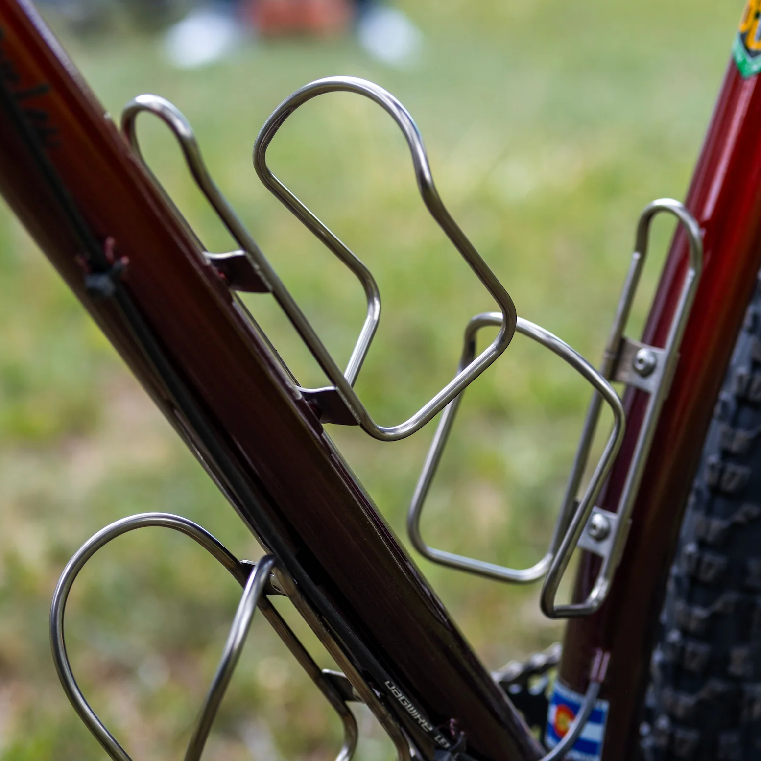 Bicycle water bottle holder on a bike frame with a blurred background