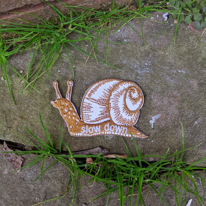 ilikesara | art + goods - Iron-on patch | slow down snail - brown 1.6" x 2.6"