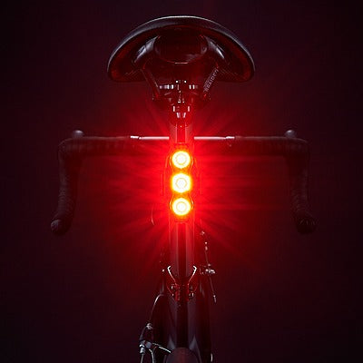 Bicycle tail light on a dark background