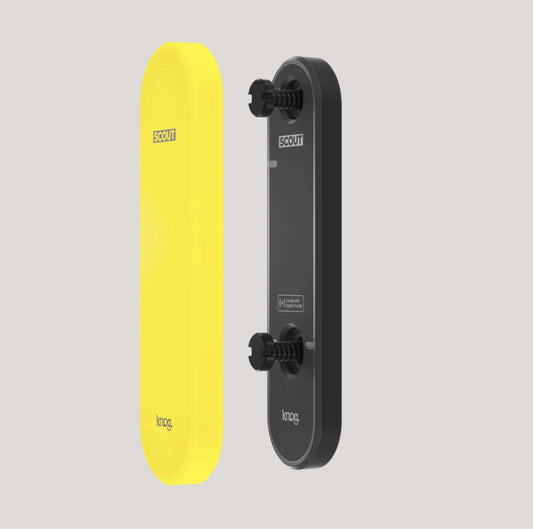 Yellow and black electric skateboard with 'Scout' branding on a light gray background