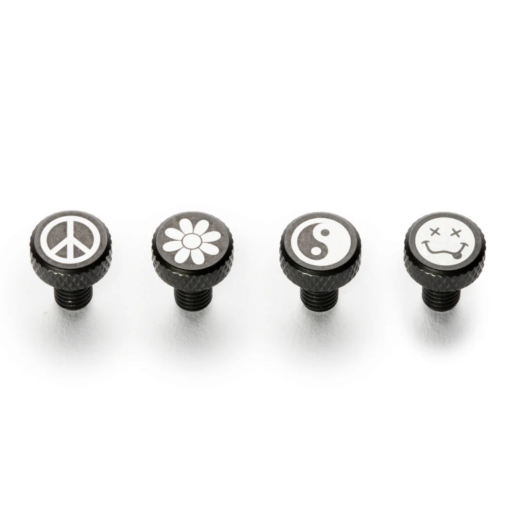 Four black knobs with symbols on a white background