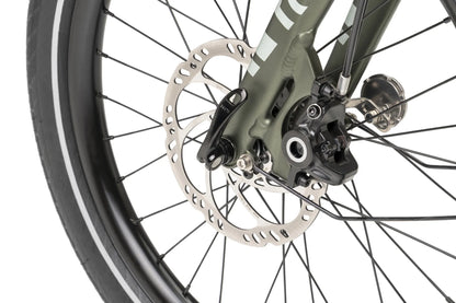 Close-up of a bicycle wheel with disc brake system on a white background