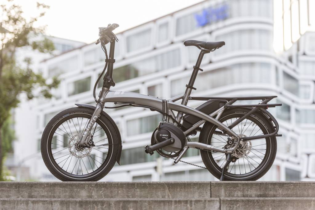 Tern foldable bicycle on a ledge with a blurred building in the background